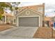 Residential home featuring a two car garage, stucco exterior, desert landscaping and tile roof at 6388 Canyon Dawn Ave, Las Vegas, NV 89108