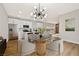 Stylish kitchen with white cabinets, stainless steel appliances, and a glass table in the dining area at 6388 Canyon Dawn Ave, Las Vegas, NV 89108
