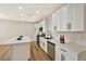 Bright kitchen featuring white cabinets, quartz countertops, stainless steel appliances and hardwood floors at 6388 Canyon Dawn Ave, Las Vegas, NV 89108