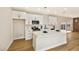 Contemporary kitchen with white cabinets, stainless steel appliances, and stone countertops and island at 6388 Canyon Dawn Ave, Las Vegas, NV 89108