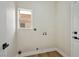 Bright laundry room features wood-look floors and washer/dryer hookups at 6388 Canyon Dawn Ave, Las Vegas, NV 89108