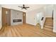 Living room features a modern electric fireplace, ceiling fan and hardwood floors at 6388 Canyon Dawn Ave, Las Vegas, NV 89108