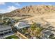 Beautiful aerial view featuring a large backyard, luxurious home, and stunning mountain views at 6999 Stone Meadows Ave, Las Vegas, NV 89142