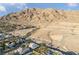 Expansive aerial view showcasing the neighborhood homes, mountains, and desert landscape at 6999 Stone Meadows Ave, Las Vegas, NV 89142