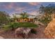 Lush backyard with well-maintained lawn, mature trees, and a spacious covered patio area at 6999 Stone Meadows Ave, Las Vegas, NV 89142