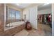 Bright bathroom featuring a bath tub and an adjacent walk in closet with plenty of light at 6999 Stone Meadows Ave, Las Vegas, NV 89142