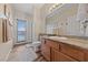 Bathroom featuring granite counters, wood cabinetry, and a walkout deck at 6999 Stone Meadows Ave, Las Vegas, NV 89142