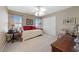 Cozy bedroom featuring a daybed, soft carpet, and ample natural light from the windows at 6999 Stone Meadows Ave, Las Vegas, NV 89142