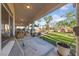 Spacious covered patio featuring views of the lush backyard, palm trees, and landscaping at 6999 Stone Meadows Ave, Las Vegas, NV 89142