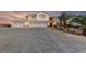Elegant two-story home featuring a spacious four car garage and a meticulously landscaped front yard at 6999 Stone Meadows Ave, Las Vegas, NV 89142