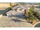 Front view of large home with a concrete driveway and three-car garage at 6999 Stone Meadows Ave, Las Vegas, NV 89142
