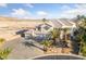 Expansive estate with a circular driveway, three-car garage, and mature landscaping at 6999 Stone Meadows Ave, Las Vegas, NV 89142