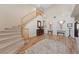 Inviting foyer with a curved staircase and high ceilings, creating a grand entrance to the home at 6999 Stone Meadows Ave, Las Vegas, NV 89142