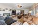 Comfortable living room with wood flooring, cozy couches, a fireplace, and a ceiling fan for added comfort at 6999 Stone Meadows Ave, Las Vegas, NV 89142