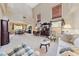 Open-concept living room with plush carpeting, high ceilings, and a view into the dining area at 6999 Stone Meadows Ave, Las Vegas, NV 89142