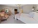 Spacious main bedroom featuring neutral colors, a plush chair, and an antique dresser with a vanity mirror at 6999 Stone Meadows Ave, Las Vegas, NV 89142