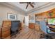 Functional home office with hardwood floors, custom cabinetry, and a well-lit workspace at 6999 Stone Meadows Ave, Las Vegas, NV 89142