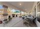 Spacious covered patio with a built-in outdoor kitchen, seating area, and landscaped yard at 6999 Stone Meadows Ave, Las Vegas, NV 89142
