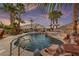 Backyard pool oasis with lush landscaping and a spacious deck for entertaining and relaxation at 6999 Stone Meadows Ave, Las Vegas, NV 89142