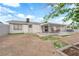 Backyard featuring covered patio with table, landscaping, and ample space at 721 Carpenter Dr, Las Vegas, NV 89107