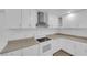 Bright kitchen featuring white cabinets, stainless steel range hood, and modern countertops at 721 Carpenter Dr, Las Vegas, NV 89107