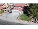 Aerial view of home with attached three-car garage, brick perimeter and a small grass yard at 7400 Amigo St, Las Vegas, NV 89123