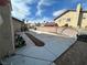 Spacious backyard with concrete paving and landscaping potential under a sunny sky at 7400 Amigo St, Las Vegas, NV 89123