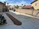 Wide concrete backyard featuring a section prepared for landscaping, ready for customization at 7400 Amigo St, Las Vegas, NV 89123