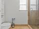 Cozy bathroom featuring tile floor, a glass enclosed shower, toilet and small window at 7400 Amigo St, Las Vegas, NV 89123