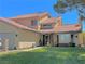 Charming two-story home with a well-maintained lawn and desert landscaping in a suburban neighborhood at 7400 Amigo St, Las Vegas, NV 89123