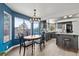 Bright kitchen and dining area with wood floors, gray cabinets, modern appliances, and backyard pool views at 7400 Amigo St, Las Vegas, NV 89123