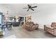 Open living space showcasing the kitchen with dining area, living room with ceiling fan and wood look floors at 7400 Amigo St, Las Vegas, NV 89123