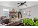 Bright living room featuring wood-look tile floors, fireplace, ceiling fan, and access to the patio at 7400 Amigo St, Las Vegas, NV 89123