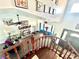 Open-concept living room with brick fireplace and staircase entry with abundant natural light at 7400 Amigo St, Las Vegas, NV 89123