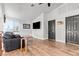 Open living room with wood flooring, modern furniture, and ample natural light from the windows at 7400 Amigo St, Las Vegas, NV 89123