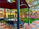 Relaxing outdoor patio with a covered dining area, a grill, and a charming swing seat by the lawn at 7400 Amigo St, Las Vegas, NV 89123