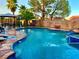 Stunning backyard pool and spa surrounded by lush landscaping for ultimate outdoor enjoyment at 7400 Amigo St, Las Vegas, NV 89123