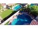 Aerial view of a backyard featuring two pools, tile patio, turf lawn and a trampoline at 7400 Amigo St, Las Vegas, NV 89123