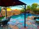 Outdoor dining and pool area perfect for entertaining with a covered gazebo and lush landscaping at 7400 Amigo St, Las Vegas, NV 89123