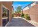 Backyard with patio. Surrounded by block wall and minimal landscaping at 7931 Mineral Peak St, Las Vegas, NV 89166