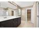Bathroom featuring double sinks, a large mirror, and a walk-in closet at 7931 Mineral Peak St, Las Vegas, NV 89166