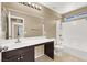Full bathroom with tub and modern vanity with great lighting, next to the primary bedroom at 7931 Mineral Peak St, Las Vegas, NV 89166