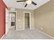 Neutral carpeted bedroom with ceiling fan with easy access to a walk-in closet and an ensuite bathroom at 7931 Mineral Peak St, Las Vegas, NV 89166