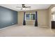 Spacious bedroom with carpet floors, ceiling fan, and blue accent wall at 7931 Mineral Peak St, Las Vegas, NV 89166
