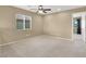 Bright bedroom with carpet floors, ceiling fan, and large window at 7931 Mineral Peak St, Las Vegas, NV 89166