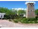 Landscaped community entrance with elegant signage and manicured greenery creating curb appeal at 7931 Mineral Peak St, Las Vegas, NV 89166