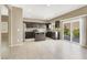 Open kitchen featuring an island, dark cabinetry, tile floors, and stainless steel appliances at 7931 Mineral Peak St, Las Vegas, NV 89166