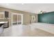 Spacious living area with tile and carpet, leading to an outdoor patio and kitchen at 7931 Mineral Peak St, Las Vegas, NV 89166