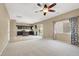 Open living space with access to kitchen, carpeted area, and bright natural light at 7931 Mineral Peak St, Las Vegas, NV 89166