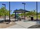 Well-maintained park featuring picnic tables, playground, and ample green space at 7931 Mineral Peak St, Las Vegas, NV 89166